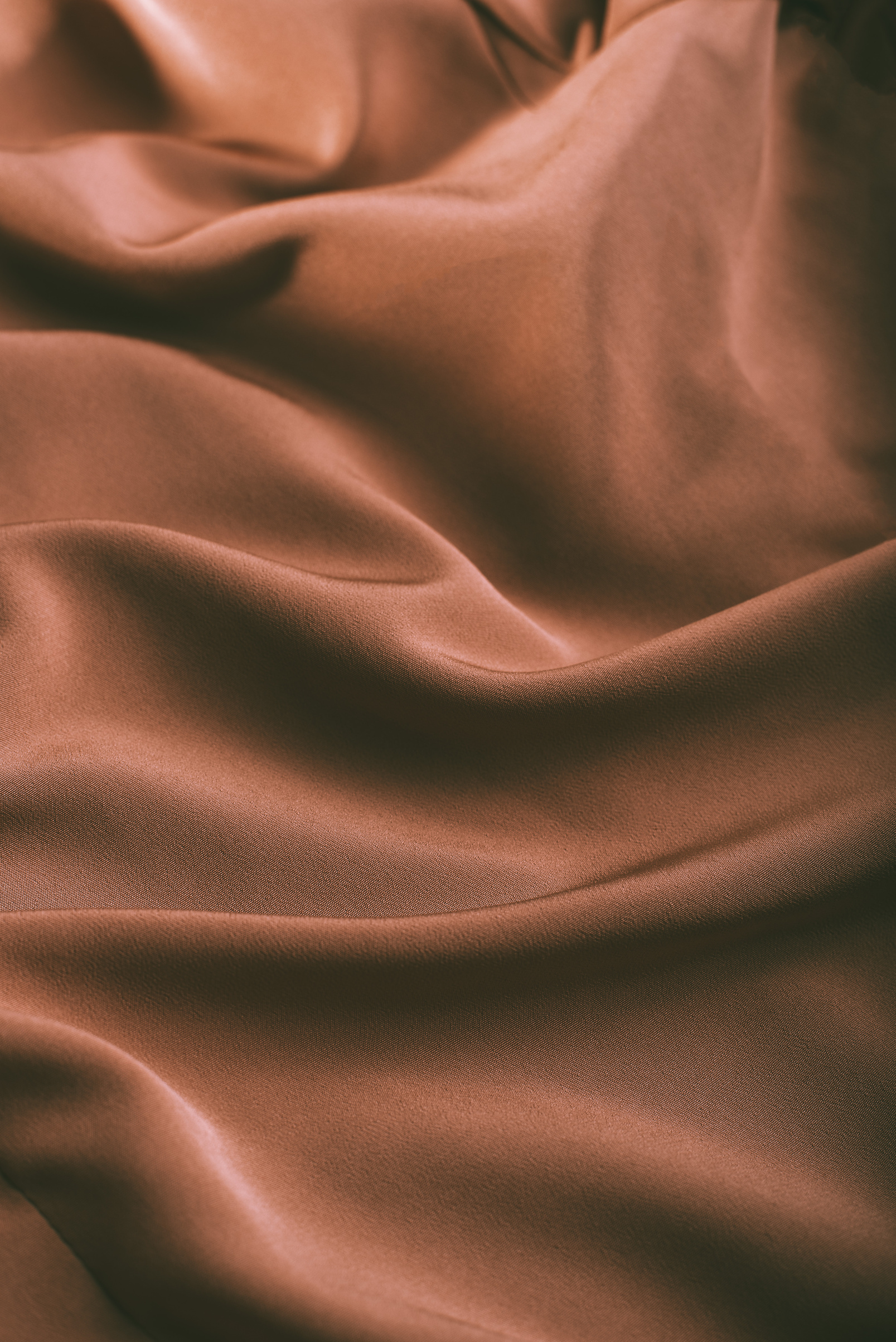 Background of smooth rippled brown silk fabric